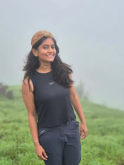 A smiling trekker enjoying the misty weather on the Gangadikal trail.