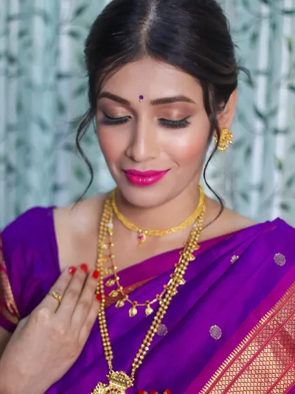 The focus here is on the flawless, radiant skin and the soft, shimmery eye makeup that makes her eyes pop.