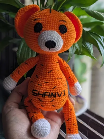 The personalized tiger doll held in hand.