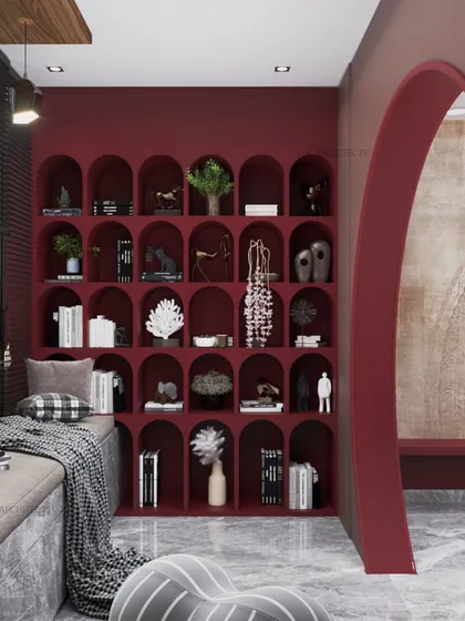A cozy reading nook designed to lift your mood. The deep red arched bookshelf creates a dramatic backdrop for a comfortable seating area, proving the power of good space design.