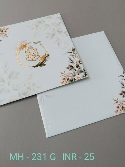 This modern floral invitation features a gold-foiled Ganesha in a geometric frame. It's a stylish blend of contemporary design and traditional blessings.