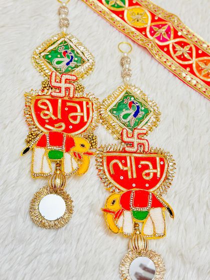 A traditional Rajasthani-style Shubh Labh latkan with elephant motifs and mirror work. This design brings a touch of ethnic royalty to your festive decorations.