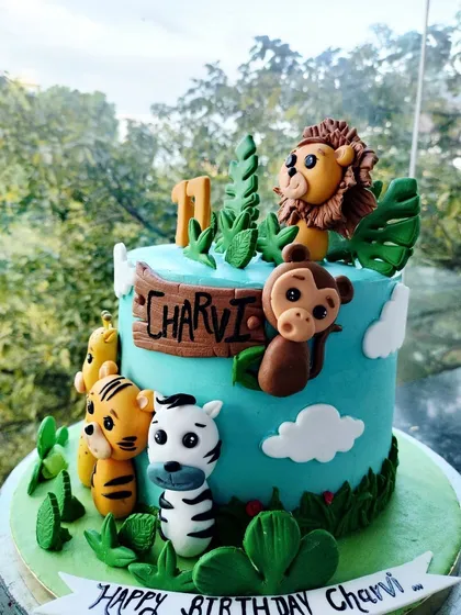 A playful jungle-themed birthday cake designed for a child's party. I love bringing your creative ideas to life with detailed fondant animals and vibrant colours to make any kid's day extra special.