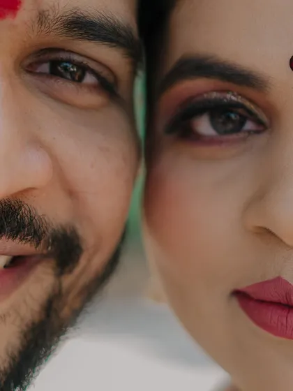 An artistic close-up that splits the frame between the bride and groom's faces. This creative shot emphasizes their features and the idea of two halves becoming one.