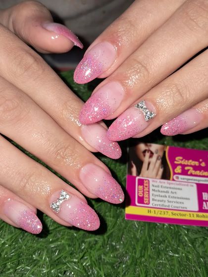 A beautiful pink ombre glitter set with sparkling 3D stone bows on the accent nails.