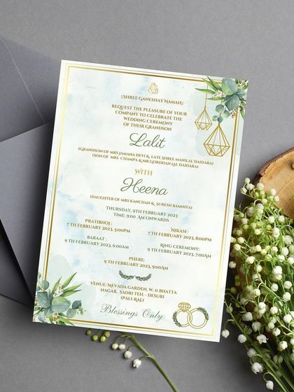 This printed wedding invitation showcases a subtle and minimal greenery theme. The design uses a soft watercolor background, delicate eucalyptus leaves, and geometric gold accents for a fresh, modern, and sophisticated look.