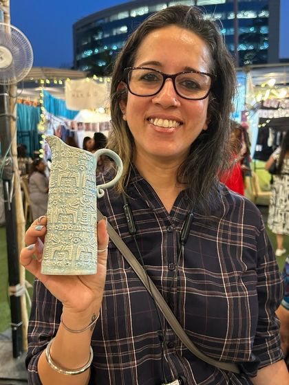 A happy customer holding one of my textured pitchers. These can be used as a vase for flowers or as a functional pitcher for drinks.