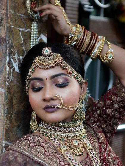 This artistic shot focuses on the stunning eye makeup and intricate matha patti, highlighting the detailed work.