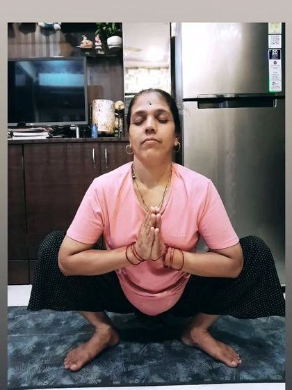 My mom holding Malasana, the Garland Pose. This shows her amazing hip flexibility and grounding, a testament to the benefits of a consistent yoga practice.