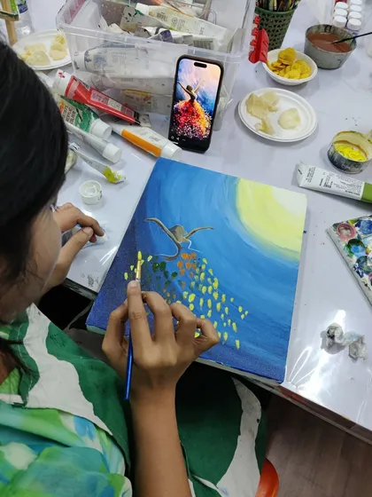 A collection of happy students from our adult canvas painting workshop, each holding their unique and beautiful landscape and abstract creations.