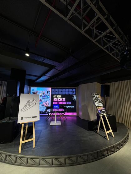 The stage setup for our "Get Your Kicks Customised" event with Broadway. We provide branded easels, stage backdrops, and professional audio-visual equipment for a complete event solution.