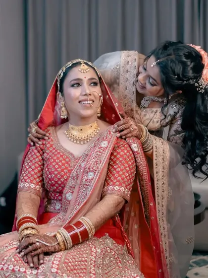 A sweet moment between the bride and her sister or friend during the getting-ready process. It's a beautiful story of love and support.