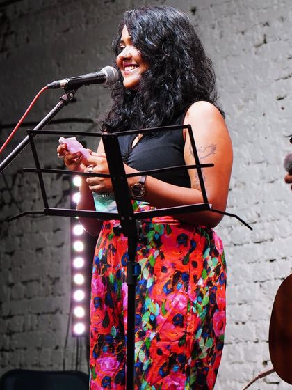 A happy moment during a solo performance. I love interacting with the audience, sharing stories behind the songs, and making everyone feel like part of the show.