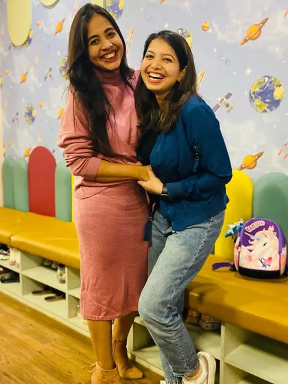 Two moms sharing a laugh while their kids play. I strive to create a cheerful and welcoming atmosphere where parents can relax and enjoy themselves just as much as the children.