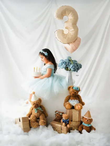 A quiet moment with the birthday cake. This sweet third birthday setup has a dreamy, 'in the clouds' feel.