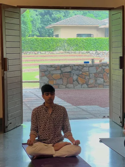 Our yoga retreats offer a chance to disconnect from the rush of life and reconnect with yourself. Here, a student finds a moment of peace and meditation, surrounded by the tranquility of nature.