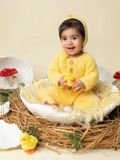 This little chick is so happy with her new toy. The simple, clean background allows the bright colors and her joyful expression to take center stage.