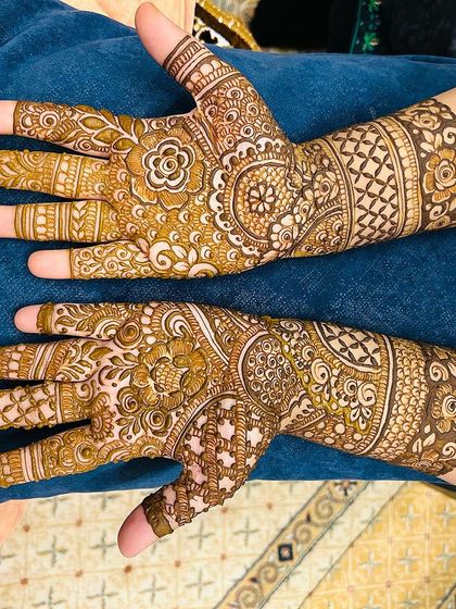 A non-bridal Indian design with a focus on the back of the hands, featuring a mix of traditional motifs.