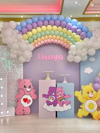 This Care Bears party is all about color and happiness. I used a pastel rainbow balloon arch as the centerpiece, complemented by adorable Care Bear character cutouts, custom name signage, and a sequin wall for that extra sparkle.