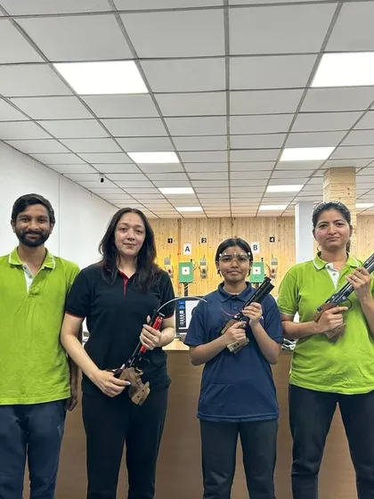 A group of adults after a recreational shooting session, holding both air pistols and air rifles. My sessions are a popular activity for friends and corporate teams looking for a new experience.