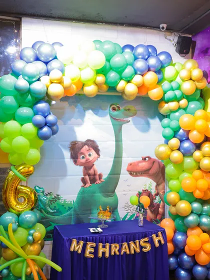 A full view of our dinosaur-themed party setup. We use vibrant balloon arches, character backdrops, and personalized banners to create a prehistoric wonderland for the birthday child and their guests.