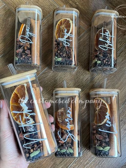 A closer look at my popular mulled wine jars. Each personalized glass comes with a bamboo lid and straw, filled with all the aromatic spices needed to create a cozy winter beverage.