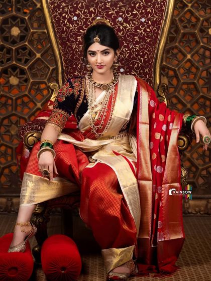 This shot from the Sreeleela series plays with a slightly different angle, highlighting the texture of the red fabric and the gleam of the sword.