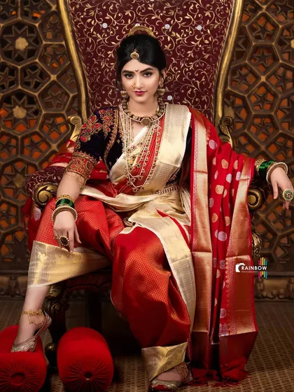 This shot from the Sreeleela series plays with a slightly different angle, highlighting the texture of the red fabric and the gleam of the sword.