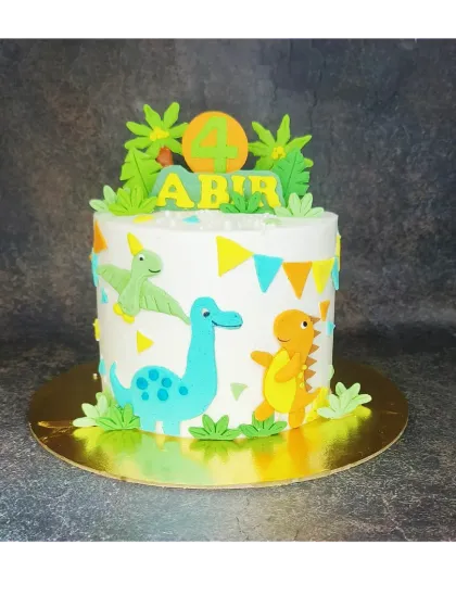 This dinosaur cake features handmade fondant dinosaurs and a colorful bunting. It's a fresh mango flavor, perfect for a 4th birthday party.