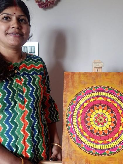 A proud artist, Bhavana, with her finished mandala. The joy of completing such a detailed and personal piece of art is immense.