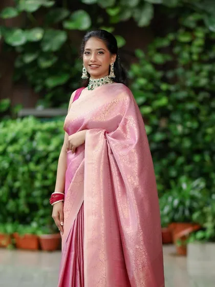 A full-length view of this graceful engagement bride. The makeup, hair, and saree draping all work in harmony to create a look of timeless South Indian elegance.