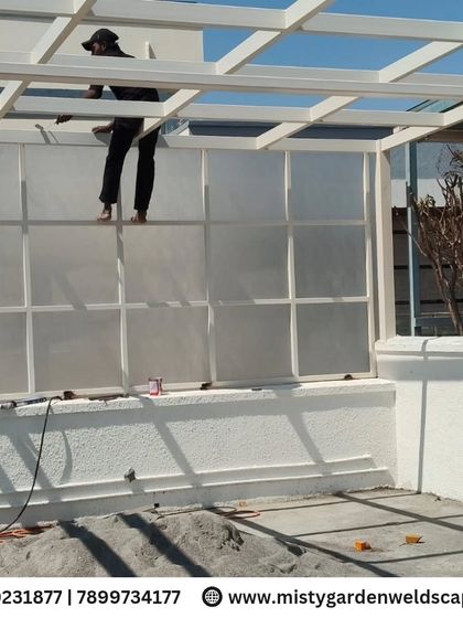 This premium 10mm toughened glass pergola at NVT Orchid Garden provides a sleek, modern look with maximum durability. The structure is enhanced with an embossed sheet side covering for added privacy and wind resistance, creating a perfect blend of luxury and function.