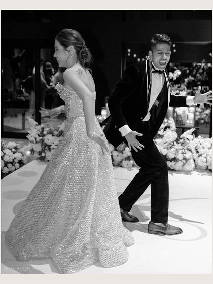 Let the party begin! This fun, high-energy black and white shot captures the couple's playful personalities as they hit the dance floor.