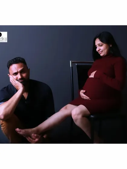 A slightly different angle of the playful foot-holding pose, showing the couple's relaxed and fun dynamic during their shoot.