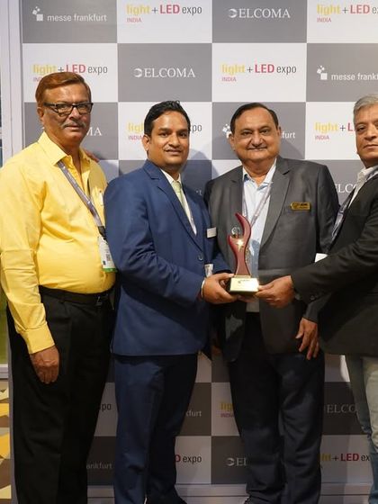 Together we are stronger. A group of partners and organizers holding a trophy to celebrate a successful collaboration.