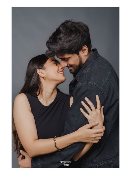 A timeless studio portrait that focuses purely on the couple's connection. Dressed in classic black, their embrace and smiles speak of a love that is both elegant and deeply felt.