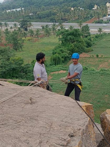 An instructor double-checks a participant's harness and rappel device before they begin their descent. This meticulous attention to safety is a cornerstone of all our training programs.