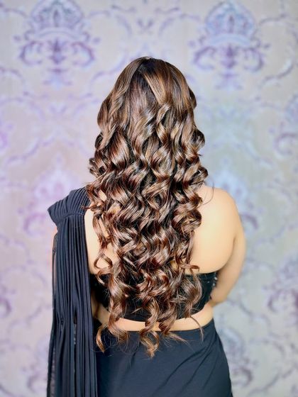 A back view showcasing the beautiful, voluminous curls that completed this glamorous party look.