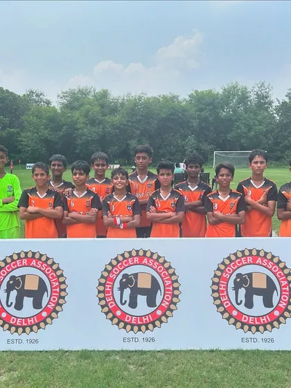 The U13 team posing behind the Delhi Soccer Association banner after a winning start to the league.