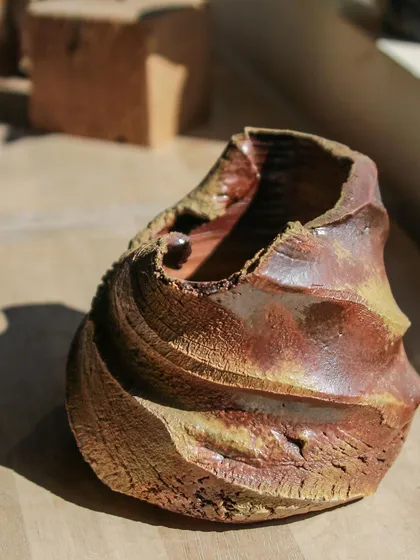 The swirling textures on this wood-fired piece were created using techniques taught by my mentor. The natural ash glaze from the kiln gives it a rich, earthy palette that cannot be replicated.