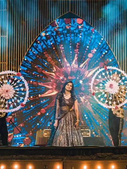 We use creative props, like these ornate umbrellas, to add a unique visual element to solo and group performances, making them stand out.
