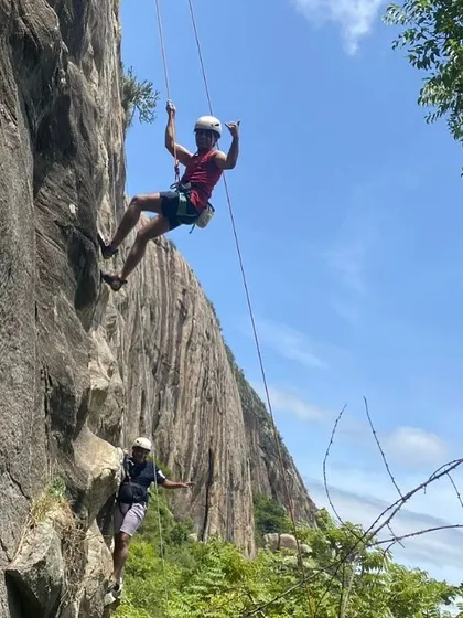 The pure joy of climbing. Yogi celebrates mid-rappel, showing the fun and playful side of our sport and community.