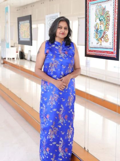 Artist Sreedevi at her 'Aaina' exhibition, standing proudly in our UB City gallery.