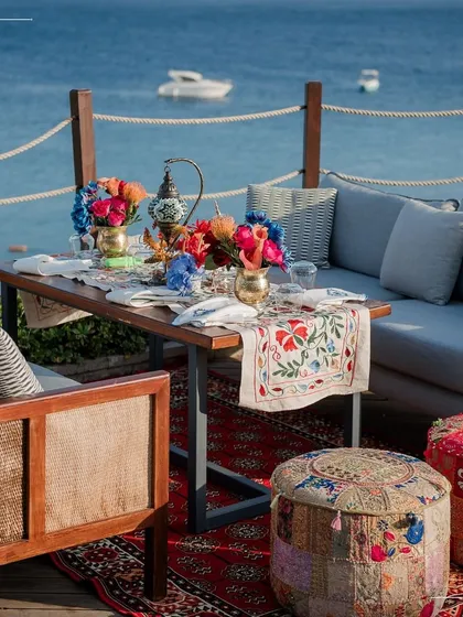A relaxed seating area on a deck overlooking the Turkish sea. We create comfortable and stylish lounge spaces for guests to enjoy the views and our hospitality.