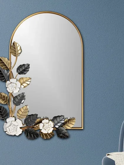 We love blending industrial materials with natural forms, and this mirror is a perfect example. A simple arched mirror is adorned with metal petals in gold, black, and white, creating a piece where floral beauty meets modern design.