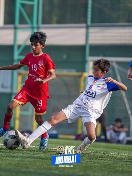 A player executing a slide tackle to win the ball back. We teach both attacking flair and defensive discipline.