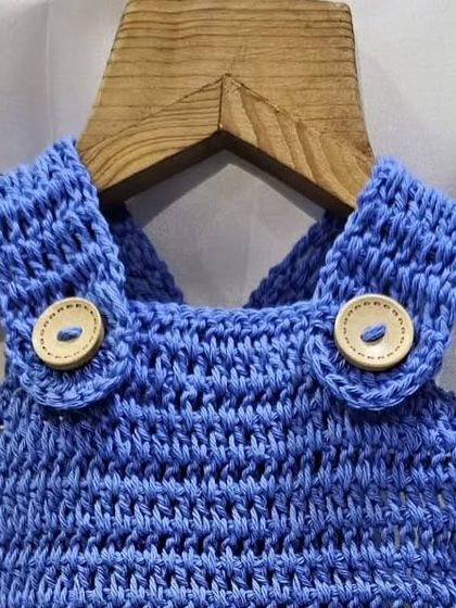 A detail shot of the wooden buttons and straps on the blue crochet romper. I always choose natural and safe materials for all my baby items.