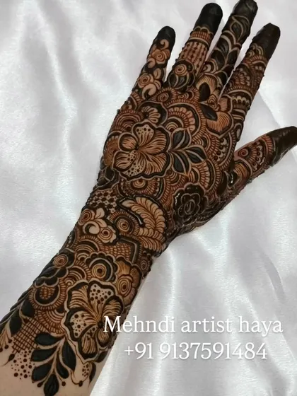 This design shows a beautiful flow from wrist to fingertips, with each part of the hand decorated with unique but complementary floral and paisley patterns.