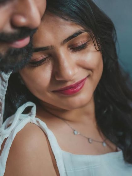 A serene and intimate close-up, where the couple finds a quiet moment together. The soft lighting enhances the gentle mood.