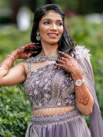 A close-up portrait that highlights the beautiful contrast between her outfit and the rich color of her mehendi.
